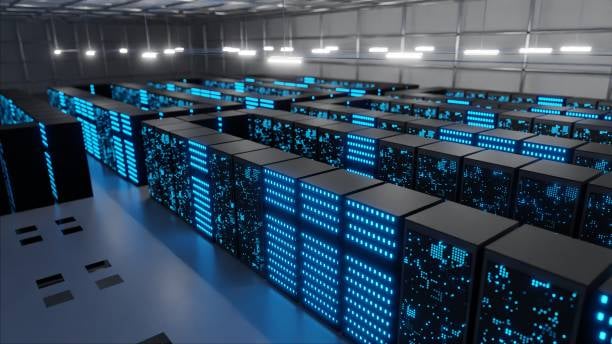 A large data center with numerous rows of servers illuminated by blue LED lights
